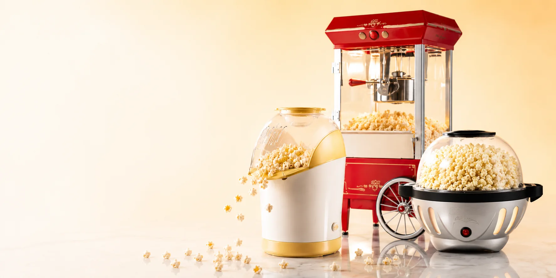 Three different types of popcorn machines side by side: hot-air popper, movie-theater cart, and kettle popcorn machine